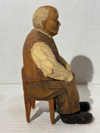 WONDERFULLY EXPRESSIVE CARVED & PAINTED FOLK PORTRAIT OF A SEATED GENTLEMAN
