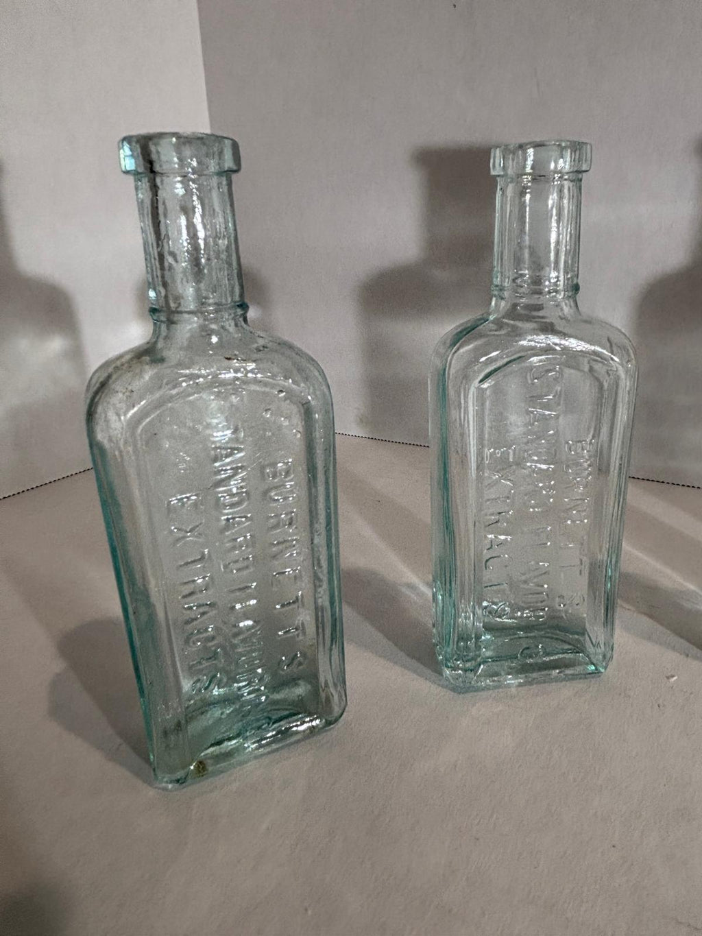 Group of Six Burnett’s Standard Flavoring Extract Bottles, Boston, Late 19th Century