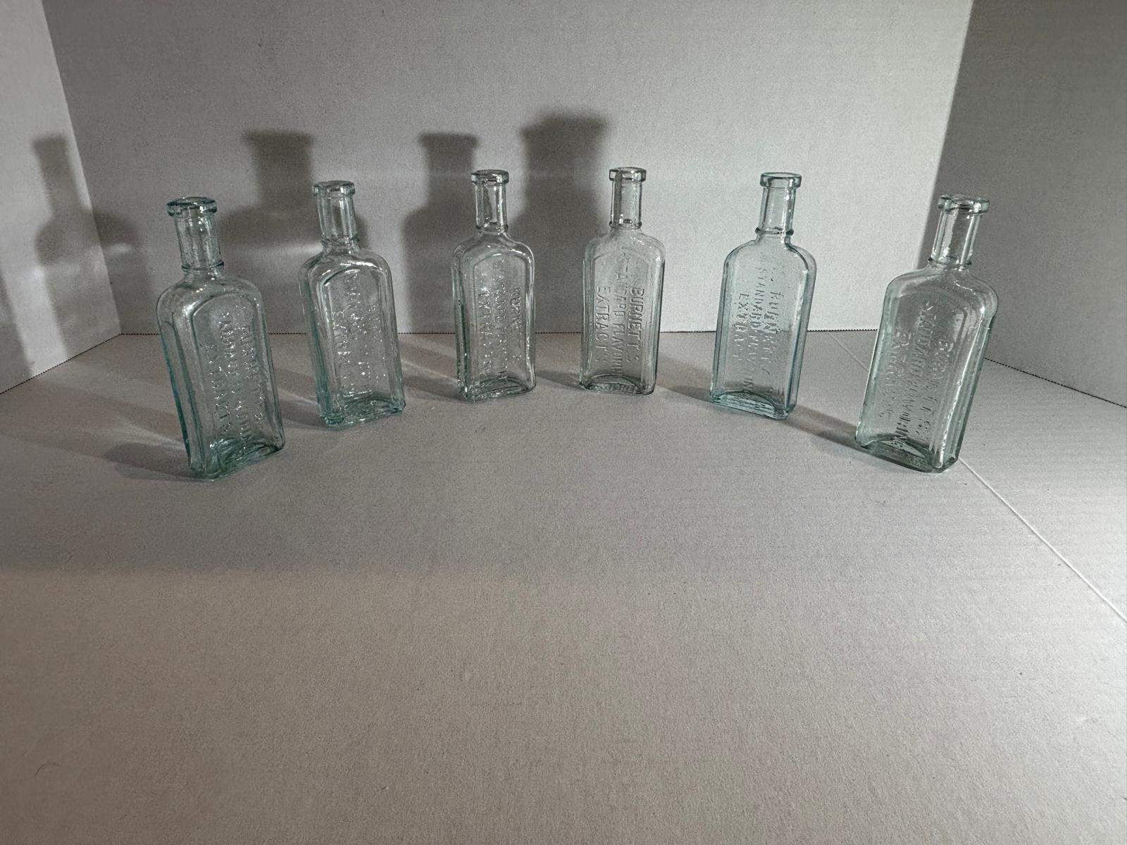 Group of Six Burnett’s Standard Flavoring Extract Bottles, Boston, Late 19th Century